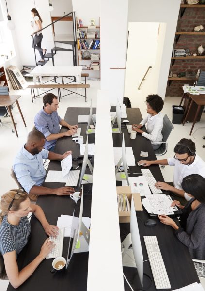 colleagues-working-at-a-busy-open-plan-office-PQMUBW3